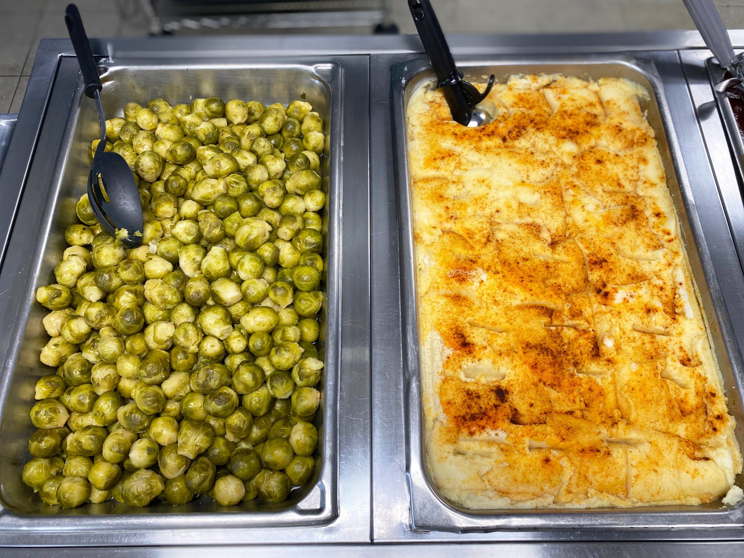 Brussel sprouts and mashed potatoes in serving trays