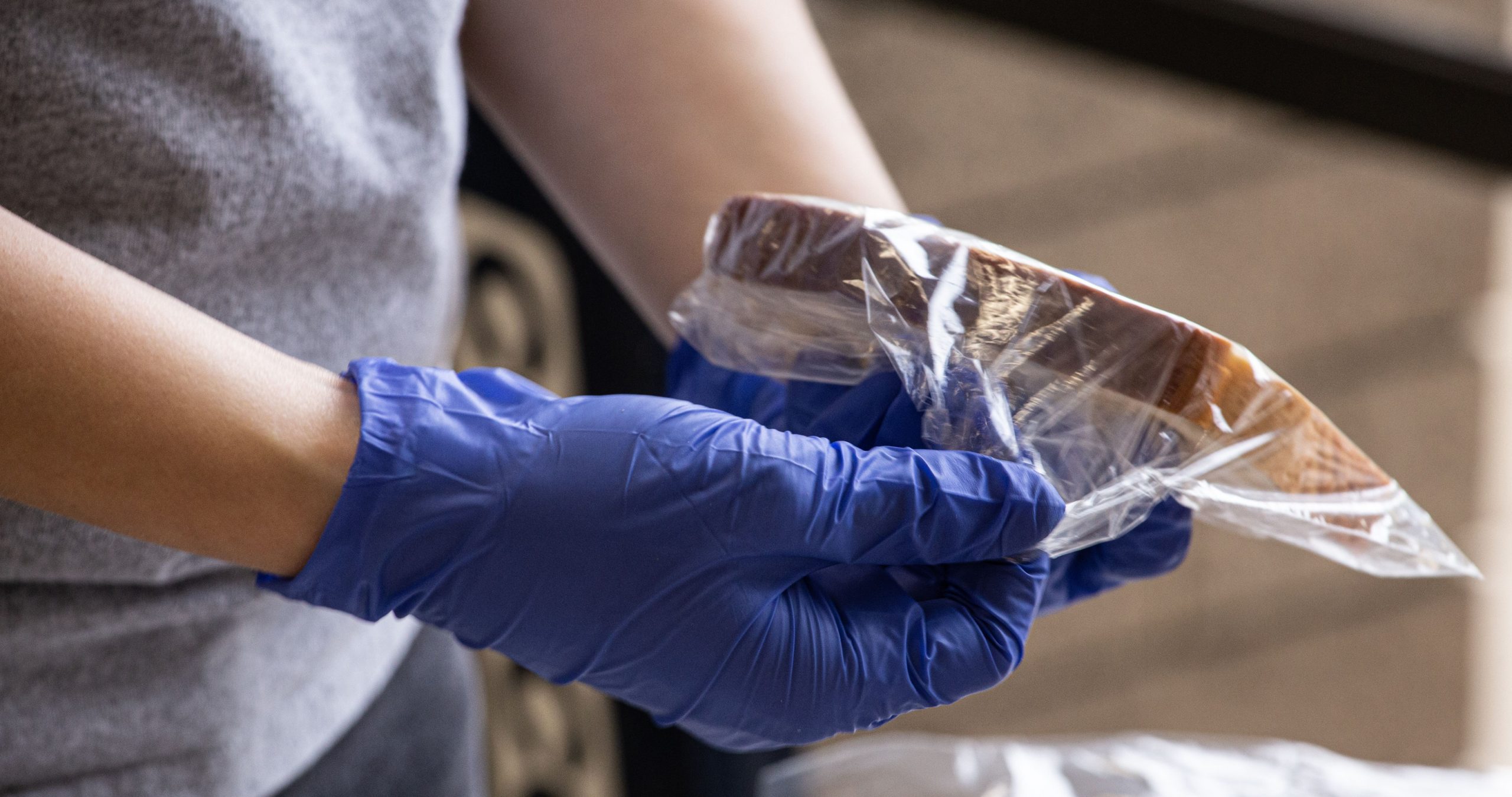 Volunteer putting bread into a bag